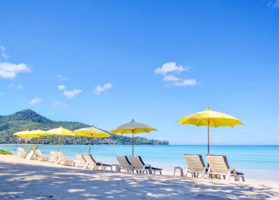 Beautiful beach with lounge chairs and yellow umbrellas