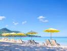 Beautiful beach with lounge chairs and yellow umbrellas