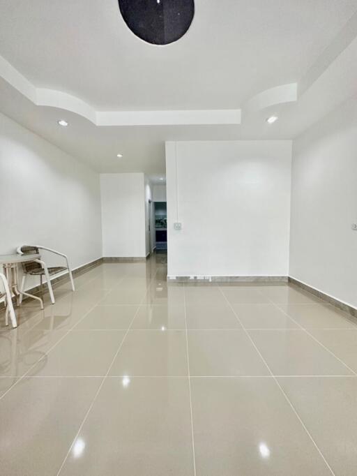 Spacious living room with modern lighting and tiled floor