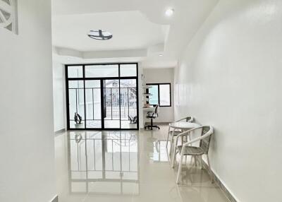 Modern bright living area with glass doors and chairs