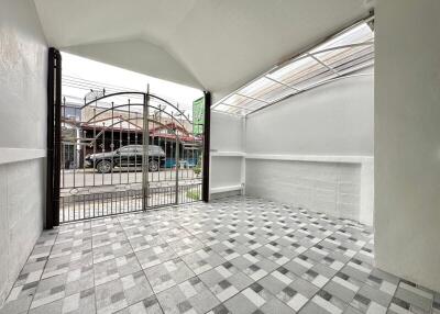 Covered outdoor space with tiled floor