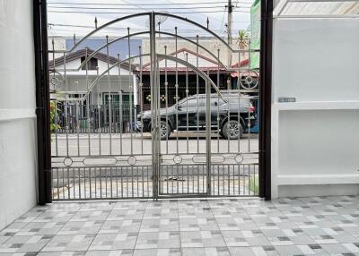 Entrance area with gate and tiled flooring