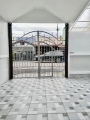 Entrance area with gate and tiled flooring