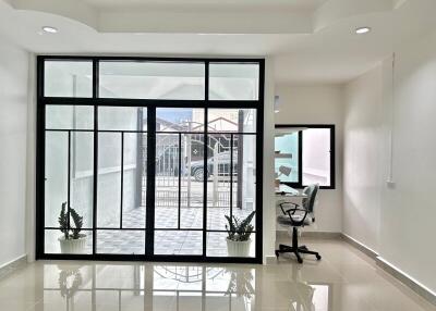 Bright living area with large glass doors and office nook