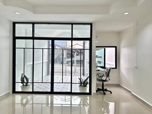 Bright living area with large glass doors and office nook