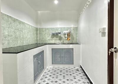 Modern kitchen with tiled backsplash and skylight