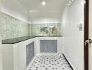 Modern kitchen with tiled backsplash and skylight