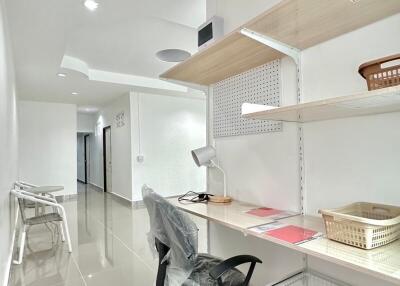 Modern home office with desk, chair, and shelves