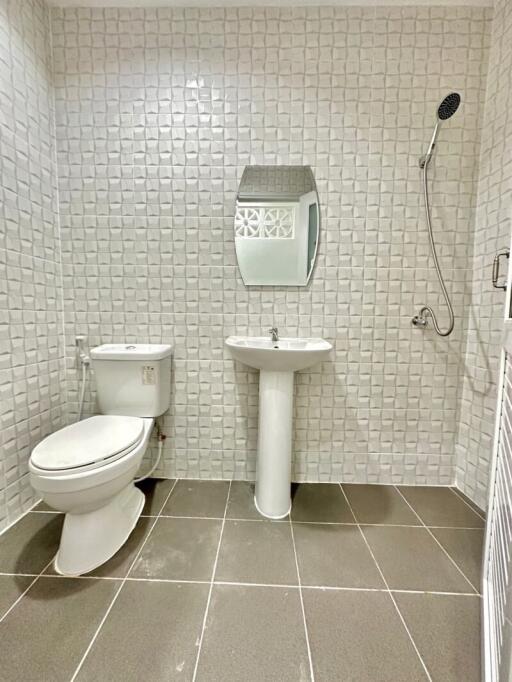 Modern bathroom with shower, toilet, and sink