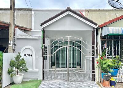 Exterior view of a house with gated entry