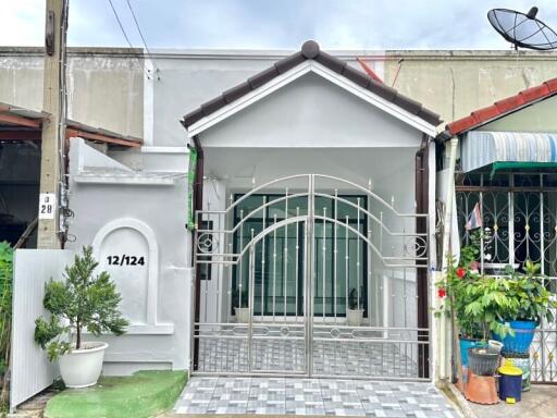 Exterior view of a house with gated entry