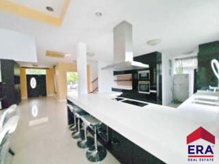 Modern kitchen with bar seating and appliances