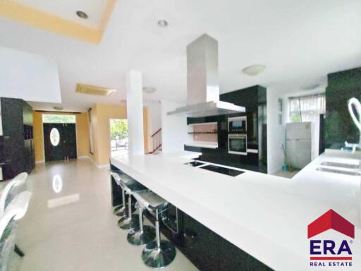 Modern kitchen with bar seating and appliances