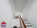 Staircase with wooden railing in a modern home