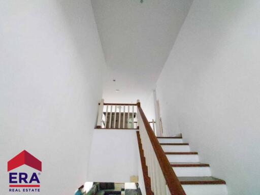 Staircase with wooden railing in a modern home