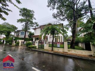 Exterior view of a property surrounded by trees on a rainy day