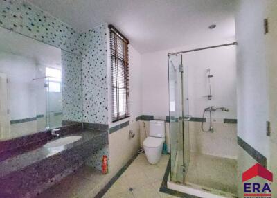 Modern bathroom with glass shower and large vanity mirror