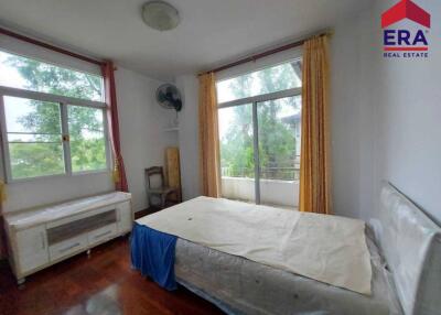 Spacious bedroom with large windows and natural light