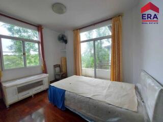 Spacious bedroom with large windows and natural light