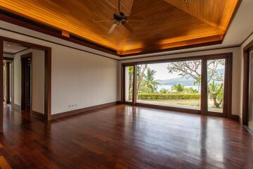 spacious living room with wooden ceiling and large windows facing a scenic view