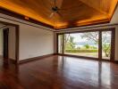 spacious living room with wooden ceiling and large windows facing a scenic view