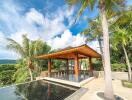 Outdoor pavilion with surrounding tropical trees and a reflective water feature