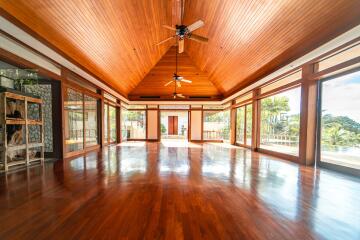 Spacious living area with wooden ceiling and floor