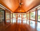 Spacious living area with wooden ceiling and floor