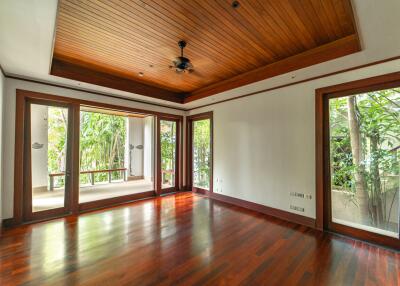 Spacious living room with large windows and wooden ceiling
