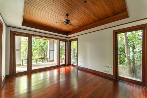 Spacious living room with large windows and wooden ceiling