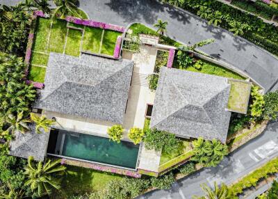 Aerial view of a residential property with lush landscaping