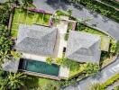 Aerial view of a residential property with lush landscaping