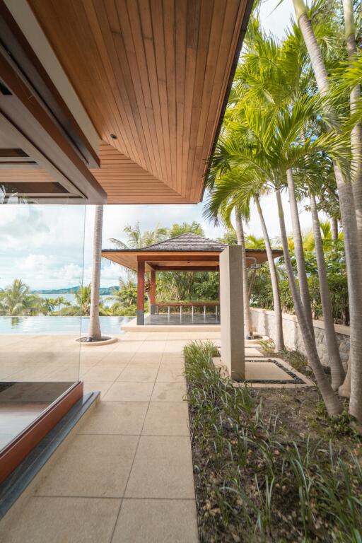 Beautiful outdoor area with patio and pool surrounded by lush greenery