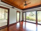 Spacious living room with polished wooden flooring and large windows