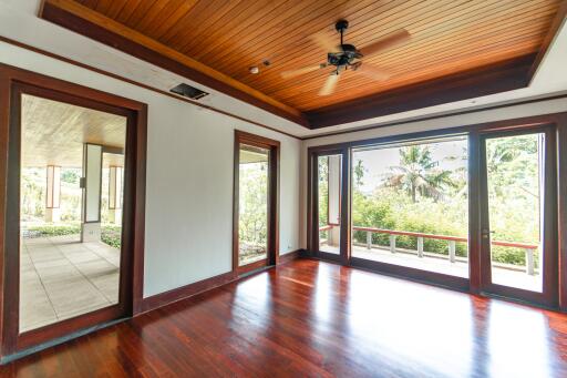 Spacious living room with polished wooden flooring and large windows