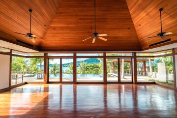 Spacious living room with large windows and wooden ceiling