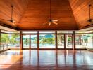 Spacious living room with large windows and wooden ceiling