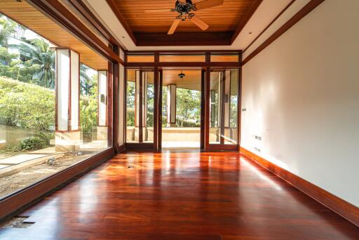 Spacious living area with wooden floors and large windows