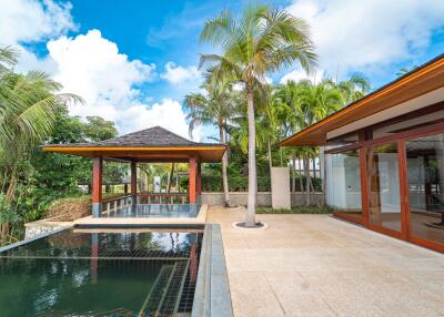 Outdoor living area with pool and palm trees