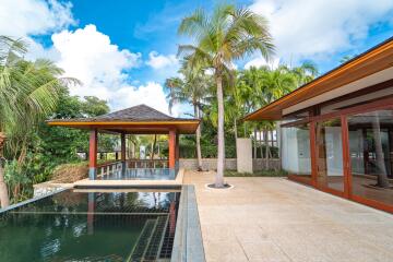 Outdoor living area with pool and palm trees