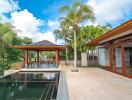 Outdoor living area with pool and palm trees