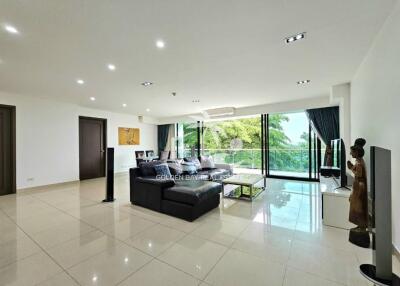 Spacious modern living room with large windows and natural light