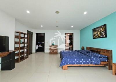 Spacious bedroom with wooden furniture and blue-themed decor