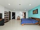 Spacious bedroom with wooden furniture and blue-themed decor