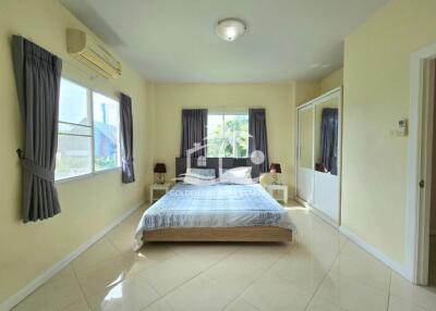 Spacious bedroom with large windows and a double bed