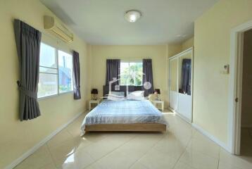 Spacious bedroom with large windows and a double bed