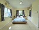 Spacious bedroom with large windows and a double bed