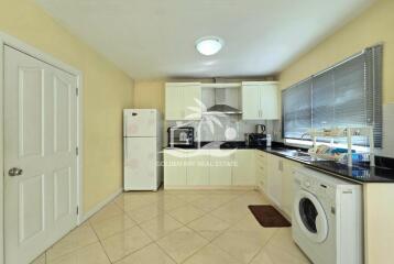 Modern kitchen with white cabinets and appliances