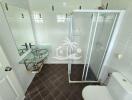 Modern bathroom with glass shower and glass sink