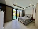 Modern bedroom with pool view and large glass door